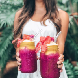 Woman holding two superfruit smoothies